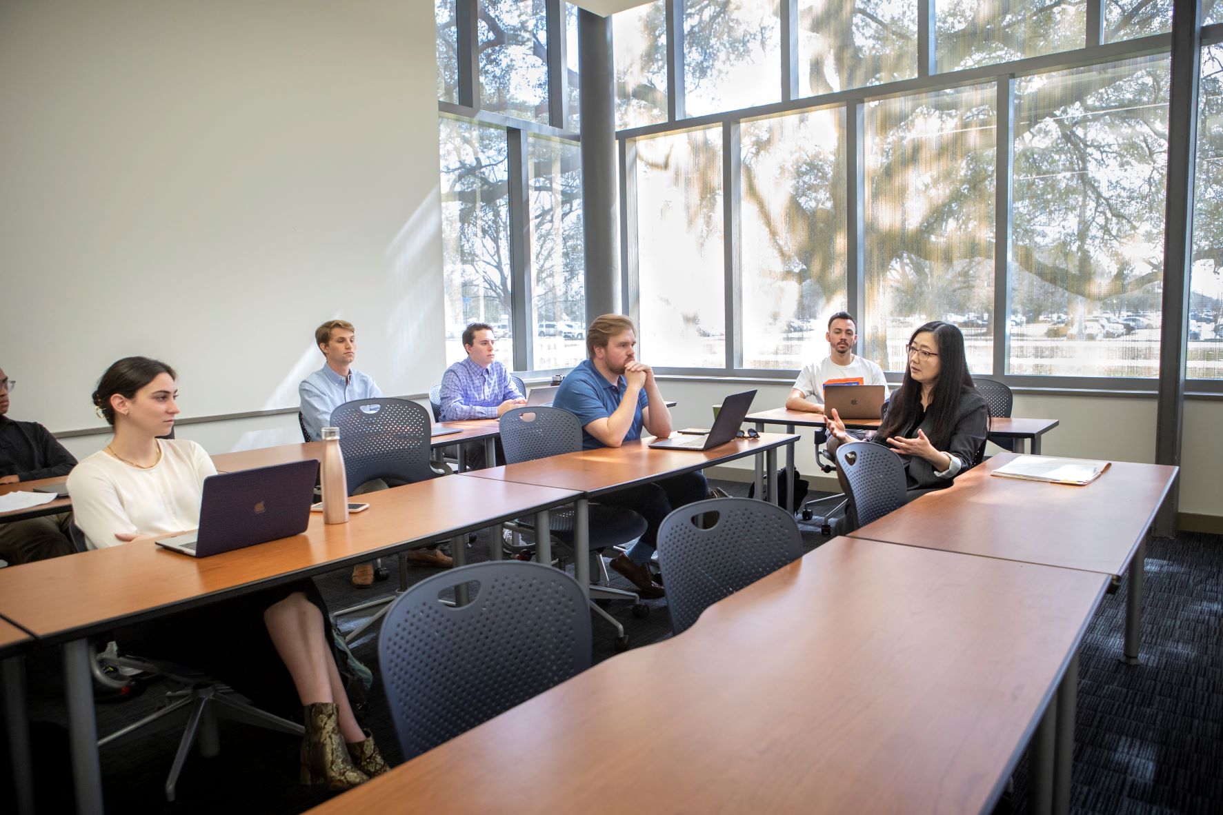 Wei-ling Song sits with MAcc students during class.