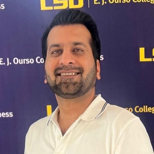 Ali Ahmed headshot on a purple LSU background