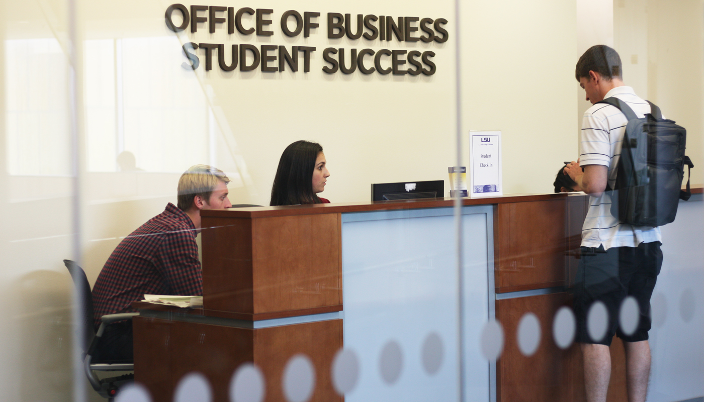 Reception area of OBSS, a student is standing at the desk. 