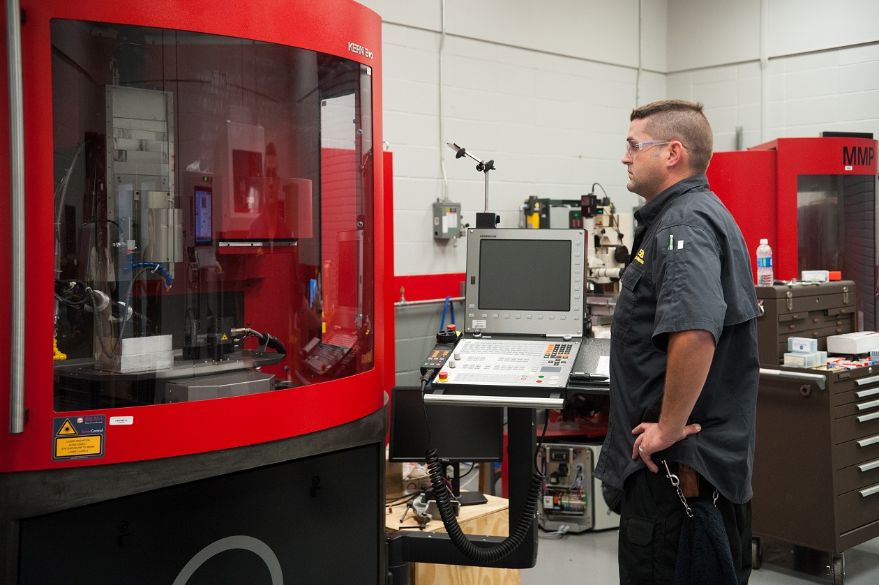 man looking at lab machine