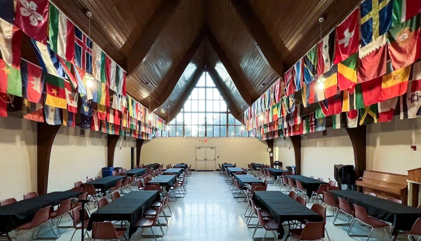 large room with flags of many nations hanging from the ceiling