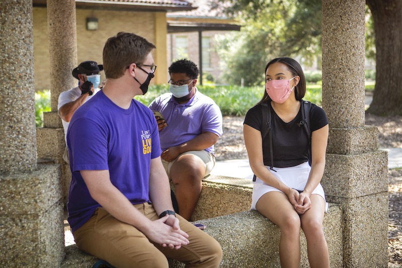 students waiting at a bus stop