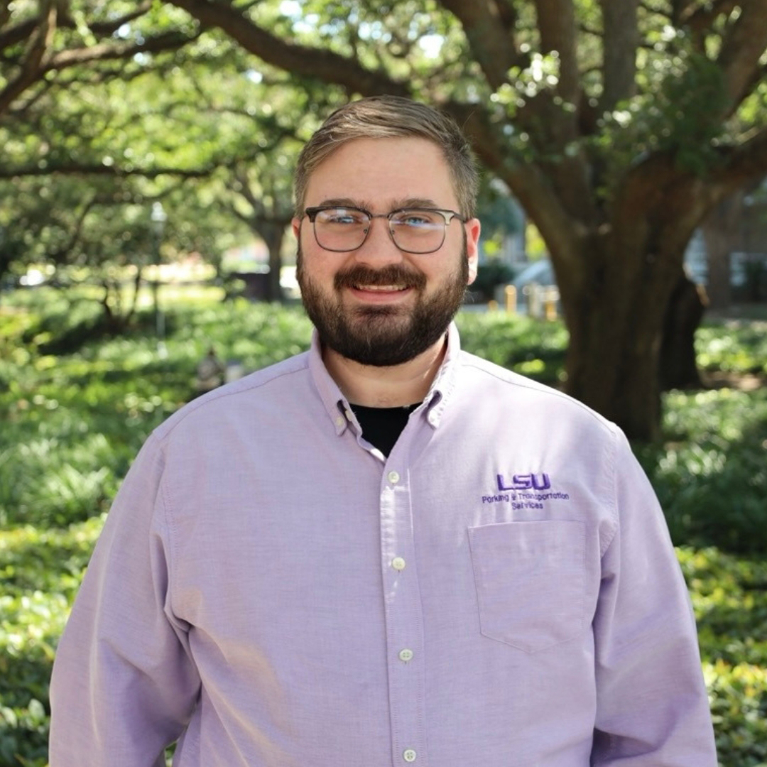 smiling man in purple polo