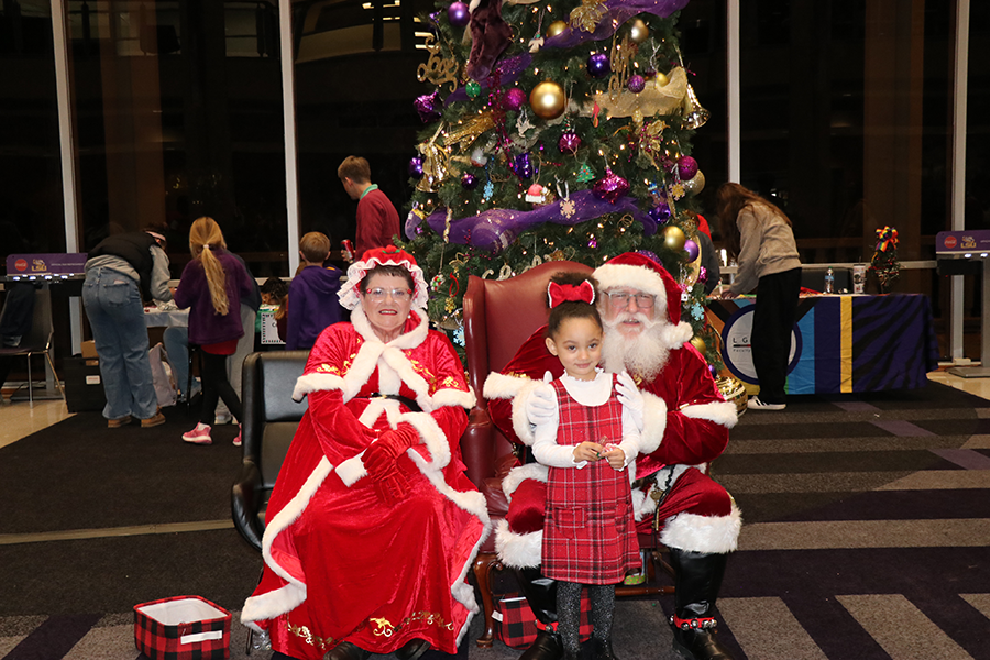 child with Santa and Mrs. Claus