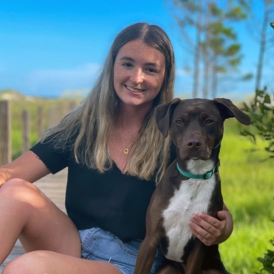 Mary Robin poses with a dog. 